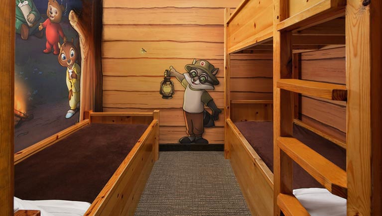 The bed and bunk beds  in the KidCabin Suite (Balcony/Patio)